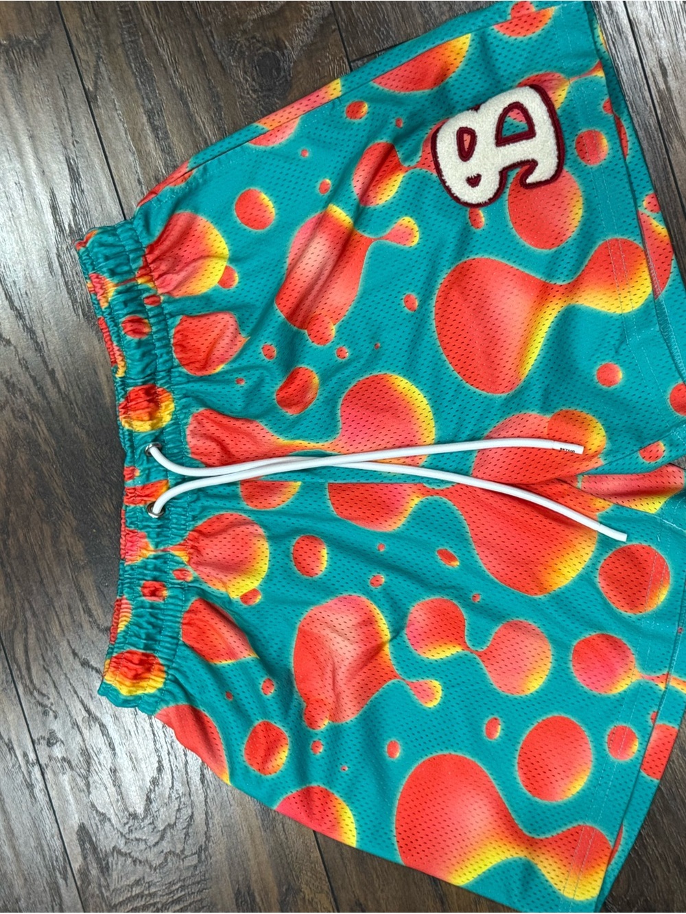 Men's Athletic Bucket Squad mesh shorts — Teal with Red-Orange Bubble Print